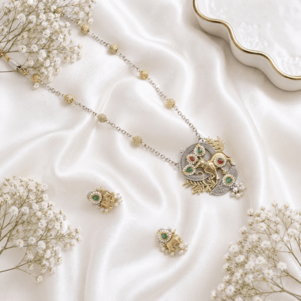 Dual-tone traditional long necklace set featuring a sacred Nandi cow motif pendant embellished with colorful stones and matching drop earrings by Kreezo.